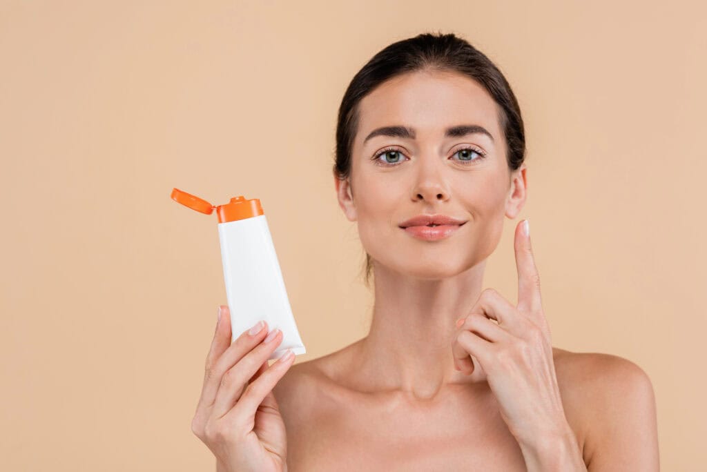 Moisturizer being dispensed into a palm ready for tanning drops
